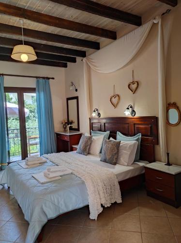 a bedroom with two beds with blue curtains at Epavli Veneti in Parga