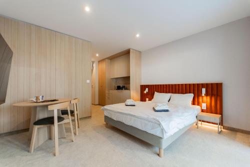 a bedroom with a bed and a table and a desk at Sunny Rest in Seashell in Łukęcin