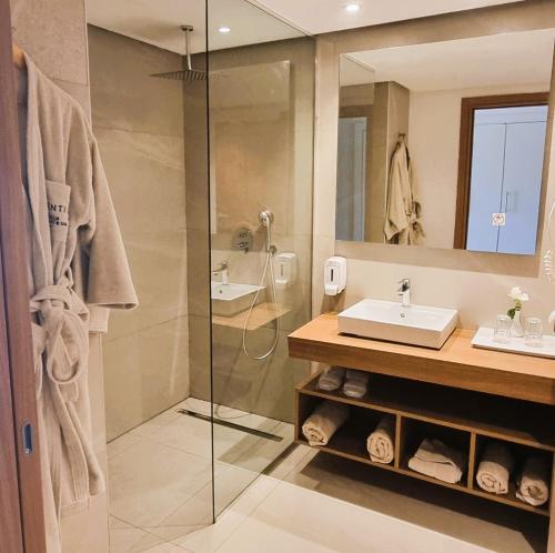 a bathroom with a shower and a sink at Sentido Marillia Resort & Spa in Hammamet