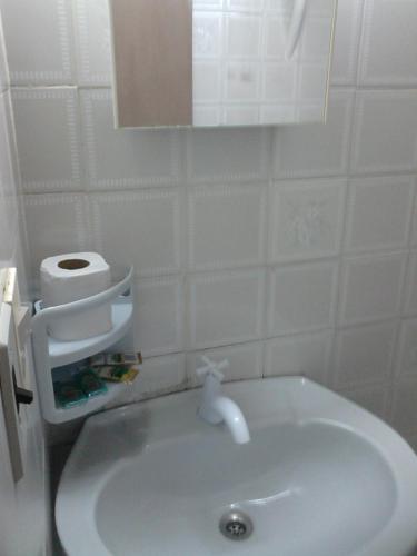 a bathroom with a white sink and a toilet at Nueva Alborada Lodging House in Fernando de la Mora