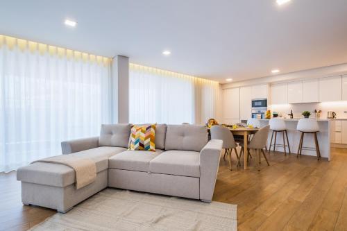 a living room with a couch and a table at The Shoreline 2 in Parede