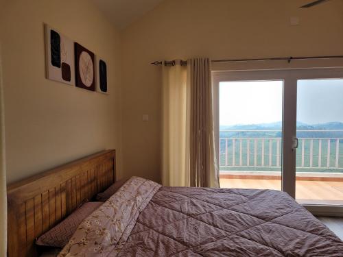 a bedroom with a bed and a large window at The Ark Haven Ooty in Kolakambe
