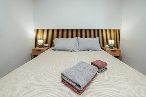 a bedroom with a bed with two towels on it at The viewpoint loft in Korinthos