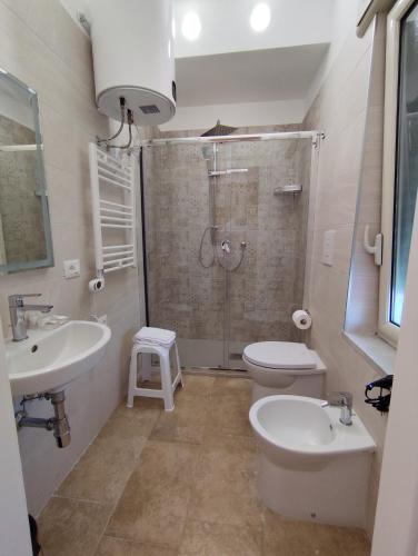 a bathroom with a shower and a toilet and a sink at La Pietra 1911 in Ercolano