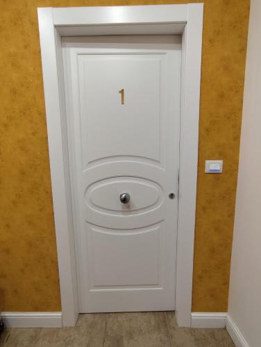 a white door with a handle in a room at La Pietra 1911 in Ercolano
