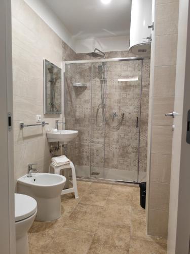 a bathroom with a shower and a sink and a toilet at La Pietra 1911 in Ercolano