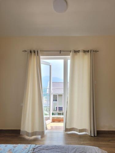 a room with a window with a curtain in front of it at The Ark Haven Ooty in Kolakambe