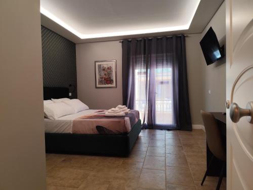 a bedroom with a bed and a window at La Pietra 1911 in Ercolano