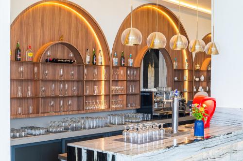 a bar with wooden walls and shelves with wine glasses at Pickalbatros Palais Des Roses - Agadir - All Inclusive in Agadir