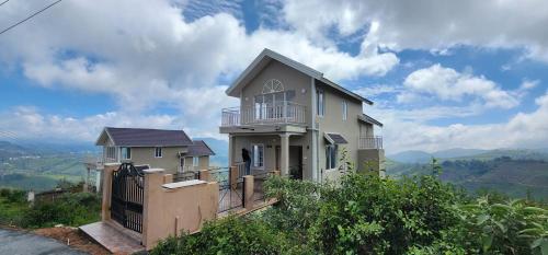 a house sitting on top of a hill at The Ark Haven Ooty in Kolakambe