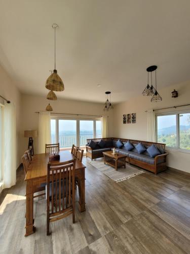 a living room with a table and a couch at The Ark Haven Ooty in Kolakambe