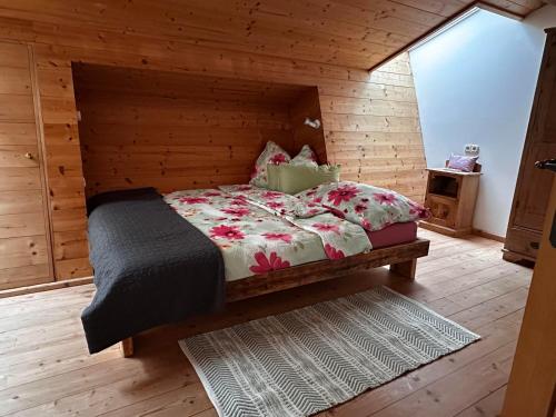 a bedroom with a bed in a wooden cabin at Obinghof in Fieberbrunn