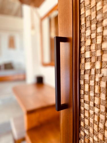 a close up of a wooden door with a table at Ammoo in Amoopi