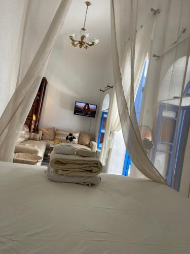 a bedroom with a bed and a living room at Ba Ali in Rabat