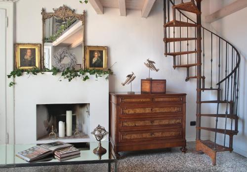 a living room with a staircase and a mirror at Arnaboldi Palace in Pavia