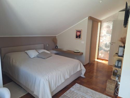 a bedroom with a white bed and a window at Il Faggio Rosso - Bed & Breakfast in Moncalieri