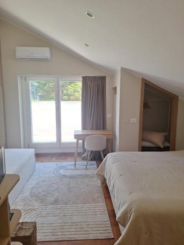 a bedroom with a bed and a desk and a window at Il Faggio Rosso - Bed & Breakfast in Moncalieri