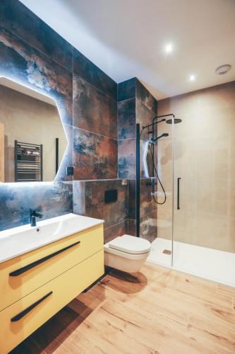 a bathroom with a sink and a toilet and a shower at Chalet de la Villette in Les Déserts