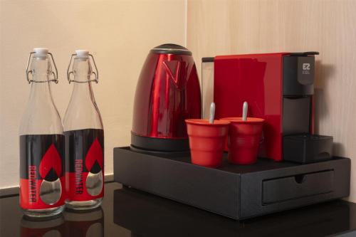 a counter with two bottles of coke and a coffee maker at Radisson RED Phuket Patong Beach in Patong Beach