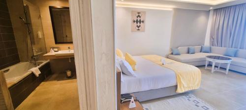 a hotel room with a bed and a bathroom at Sentido Marillia Resort & Spa in Hammamet