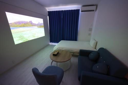 a room with a couch and a bed and a table at The Marina Bay in Fukuoka