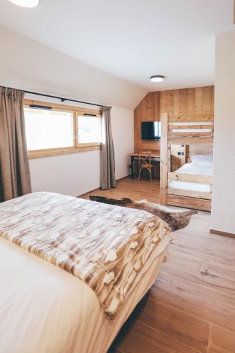 a bedroom with a large bed in a room at Chalet de la Villette in Les Déserts