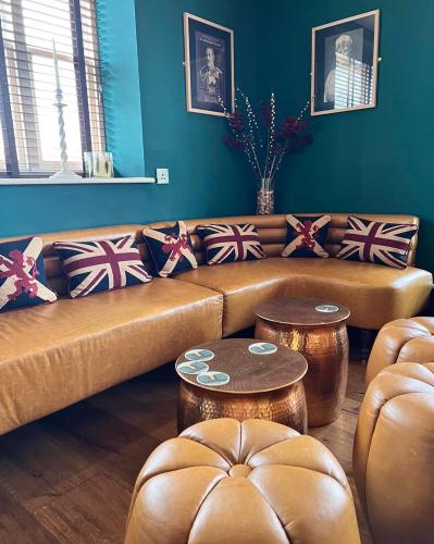 a living room with two brown couches and tables at The Kings Head Inn, Norwich - AA 5-Star rated in Norwich