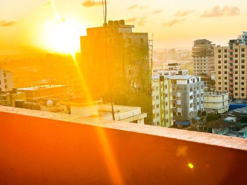 a view of a city with the setting sun at Urban Affordable Private City Room- Amazing View, Fast WiFi & Walkable Location in Dar es Salaam