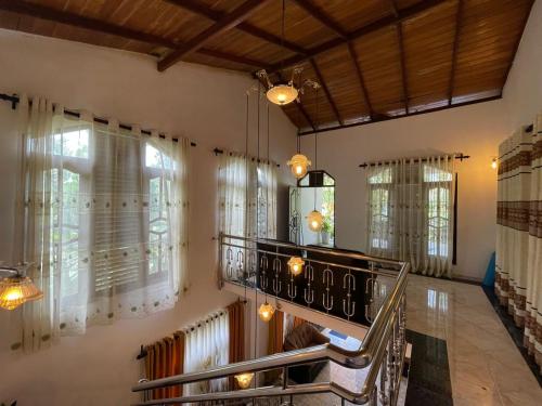 a living room with windows and a stove at Sea Waves Home Stay in Talalla