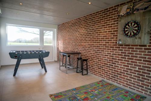 a room with a dart board on a brick wall at Vakantiehuis 't Alkeveld in Zottegem