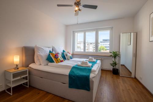 a bedroom with a large bed with a window at Special TRIO PICASSO Apartment Basel, Bahnhof Grossbasel 10-STAR in Basel