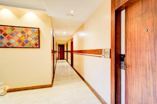a hallway in a house with a painting on the wall at FabHotel Arastu Plaza - Nr Nampally Railway Station in Hyderabad