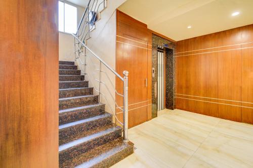 a staircase in a building with wooden walls and a stair case at FabHotel Arastu Plaza - Nr Nampally Railway Station in Hyderabad