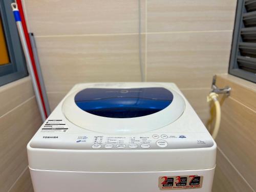 a washing machine sitting next to a door at 3 Towers Jalan Ampang By Serenity Vacation Homes in Kuala Lumpur