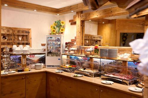 a kitchen with a counter with food on it at Hotel Eder Michaela in Saalbach Hinterglemm