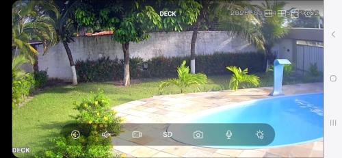 a view of a yard with a swimming pool at Casa praia Paracuru in Paracuru