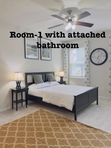 a bedroom with a bed with a ceiling fan at Abi home in Brandon