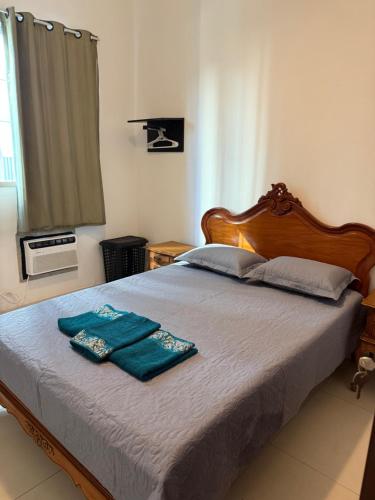 a bedroom with a bed with two towels on it at Apartamento Aconchegante em Botafogo in Rio de Janeiro