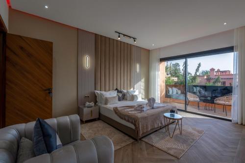 a bedroom with a bed and a living room with a couch at Villa Mareva & Spa Marrakech in Marrakesh