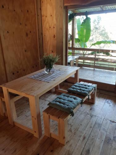 a wooden table and benches in a room at Sielerus in The Crags