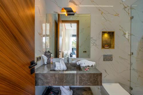 a bathroom with a sink and a mirror at Villa Mareva & Spa Marrakech in Marrakesh