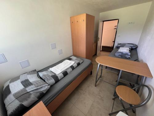 a small bedroom with a bed and a desk at Ubytování ProDante in Ostrava