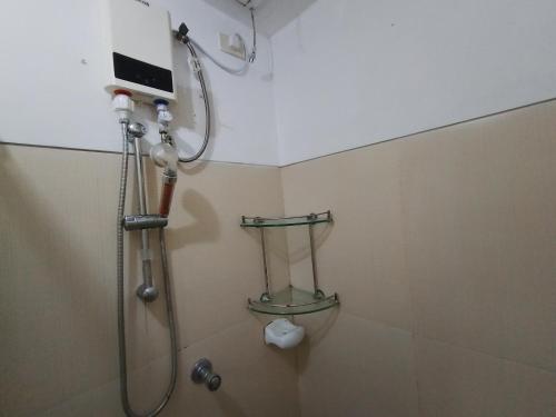 a bathroom with a shower with a shower head at Fully Furnished 1 Bedroom Condo Unit in Manila