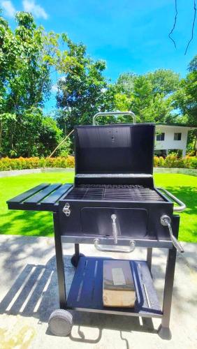 a barbecue grill sitting on a sidewalk in a park at Kiddie Hostel 13A1-Kids and pets friendly in Kababae