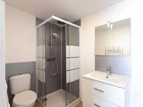 a bathroom with a shower and a toilet and a sink at Ty Bihan by Madame Est Servie in Pleumeur-Bodou