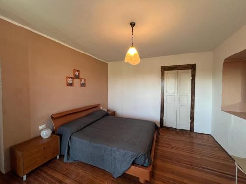 a bedroom with a bed and a pendant light at Cascina Zanta in Valdengo