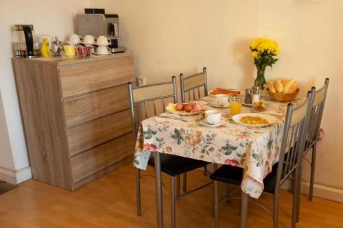 a table with a plate of food on it at Apartmány Holiday in Ostrava
