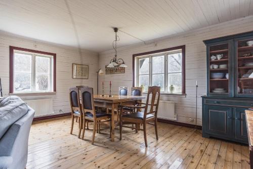 a dining room with a table and chairs at Charming Forest Retreat, 15 Min from Mariefred in Nykvarn