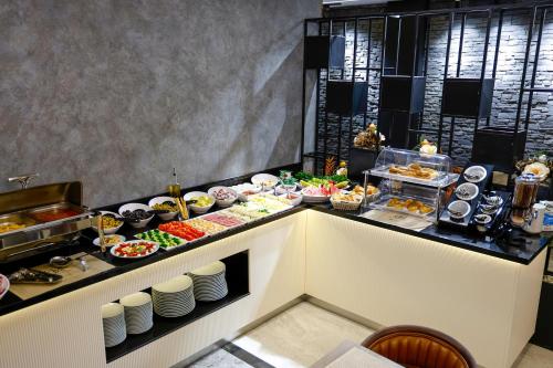 a buffet line with many different types of food at Gezgin Hotel in Edirne