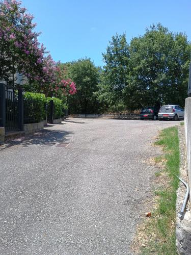 an empty street with cars parked in a driveway at La Villetta in Rende